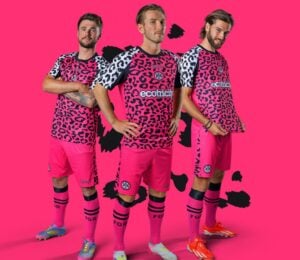 Photo shows three Forest Green Rovers players wearing the new neon pink away kits