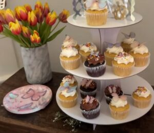 A layout of tulips, vegan cupcakes, and butterfly plates for a kids vegan birthday party