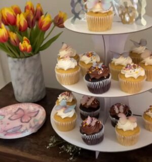 A layout of tulips, vegan cupcakes, and butterfly plates for a kids vegan birthday party
