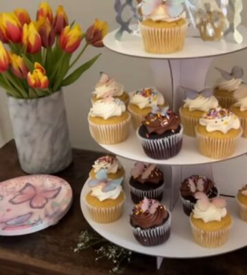 A layout of tulips, vegan cupcakes, and butterfly plates for a kids vegan birthday party