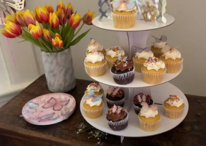 A layout of tulips, vegan cupcakes, and butterfly plates for a kids vegan birthday party