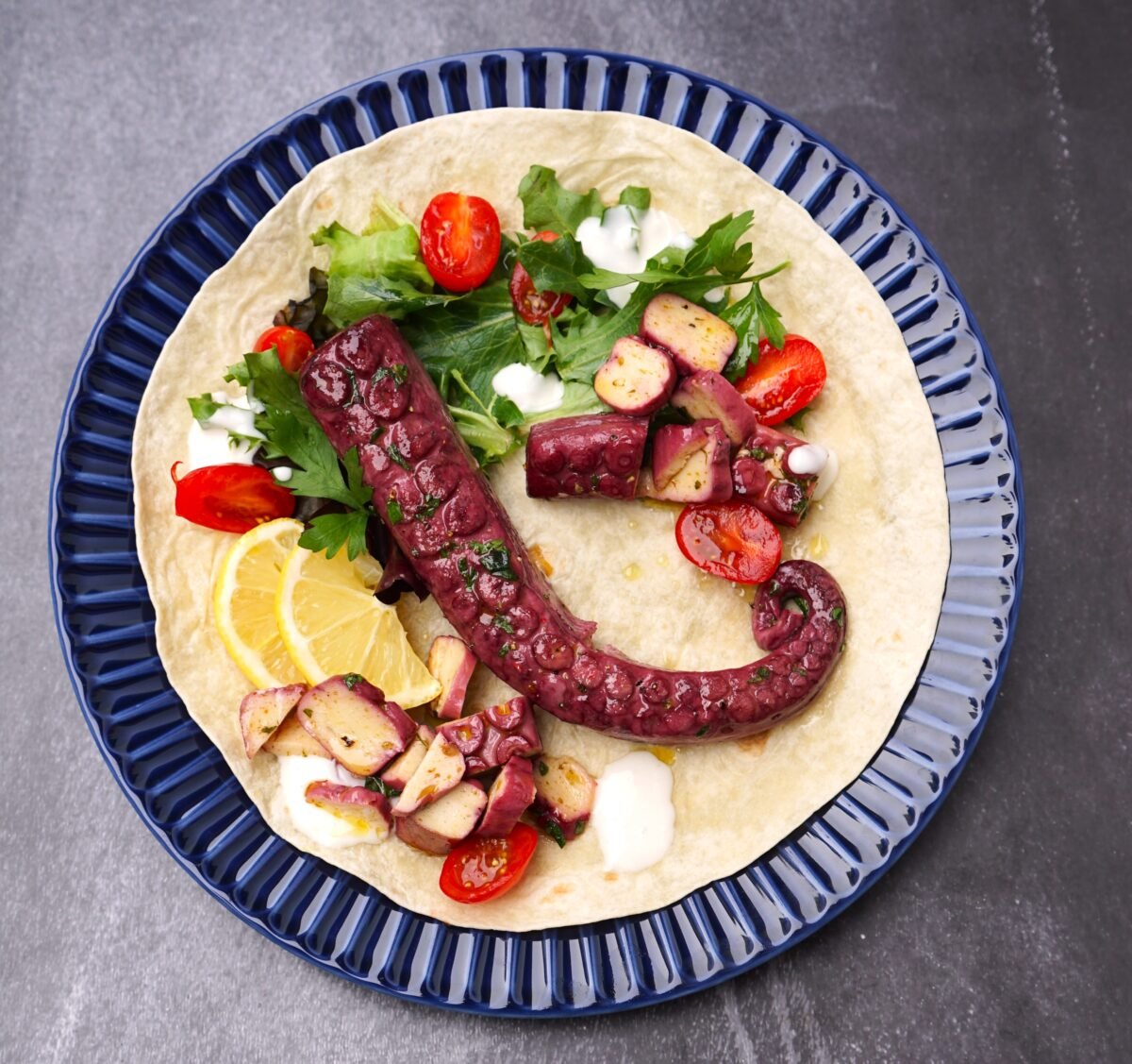Photo shows THE KRAKEN, the vegan octopus product from Revo Foods, served with a fresh salad