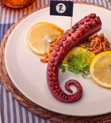 Photo shows THE KRAKEN, the vegan octopus product from Revo Foods, served with fresh lemon and herbs