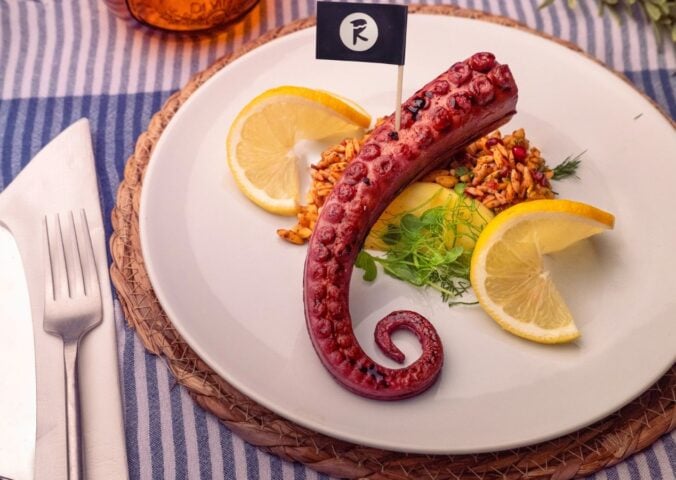 Photo shows THE KRAKEN, the vegan octopus product from Revo Foods, served with fresh lemon and herbs
