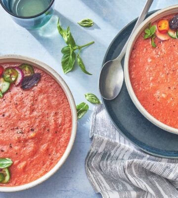 two bowls of watermelon gazpacho made with watermelon, tomato, cucumber, and herbs for vegan starter ideas for your next dinner party