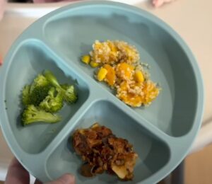 A mother serving her vegan baby plant-based food