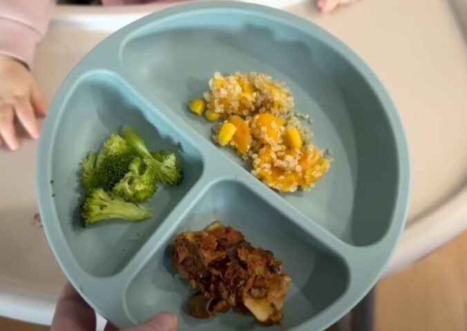 A mother serving her vegan baby plant-based food
