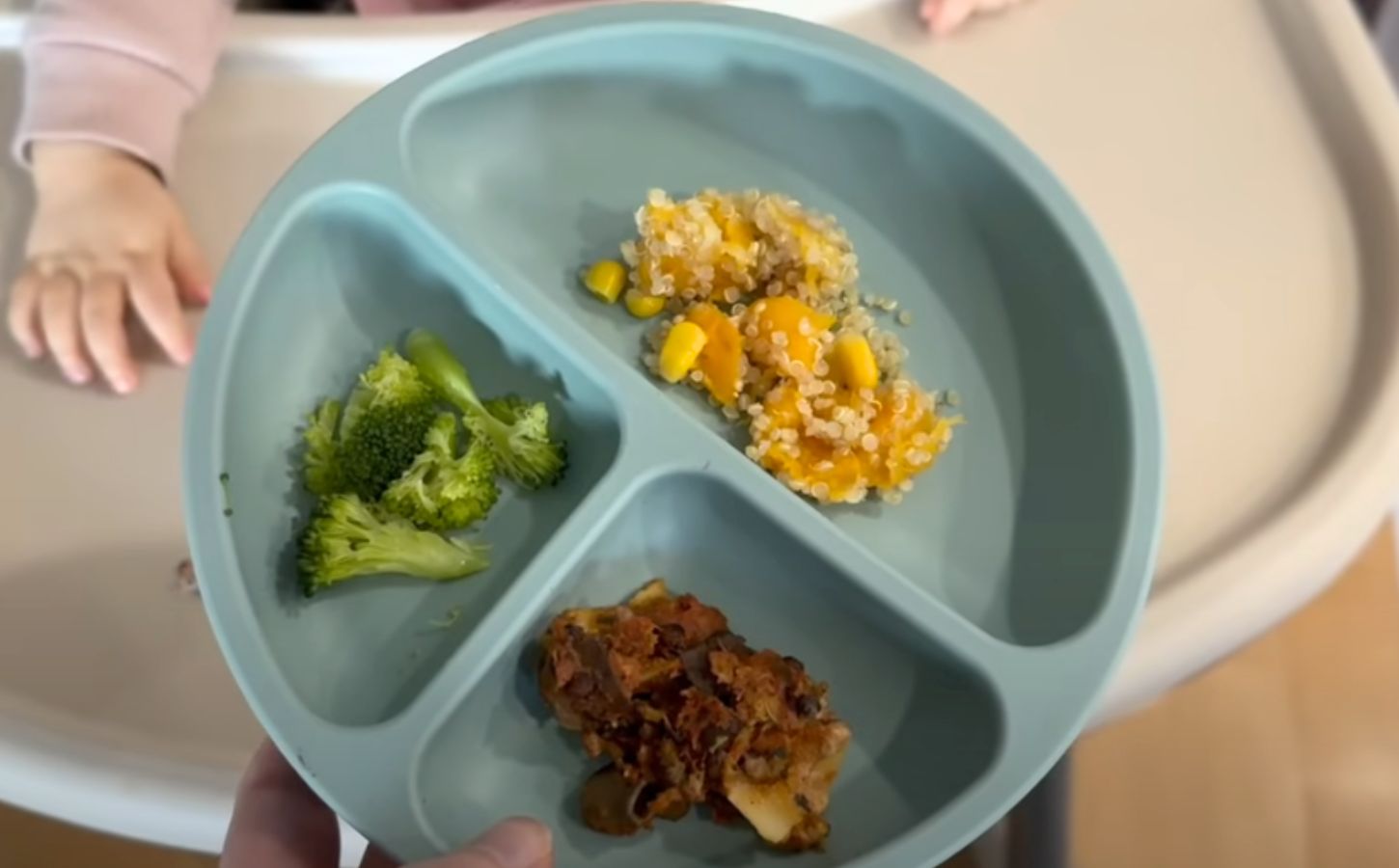 A mother serving her vegan baby plant-based food