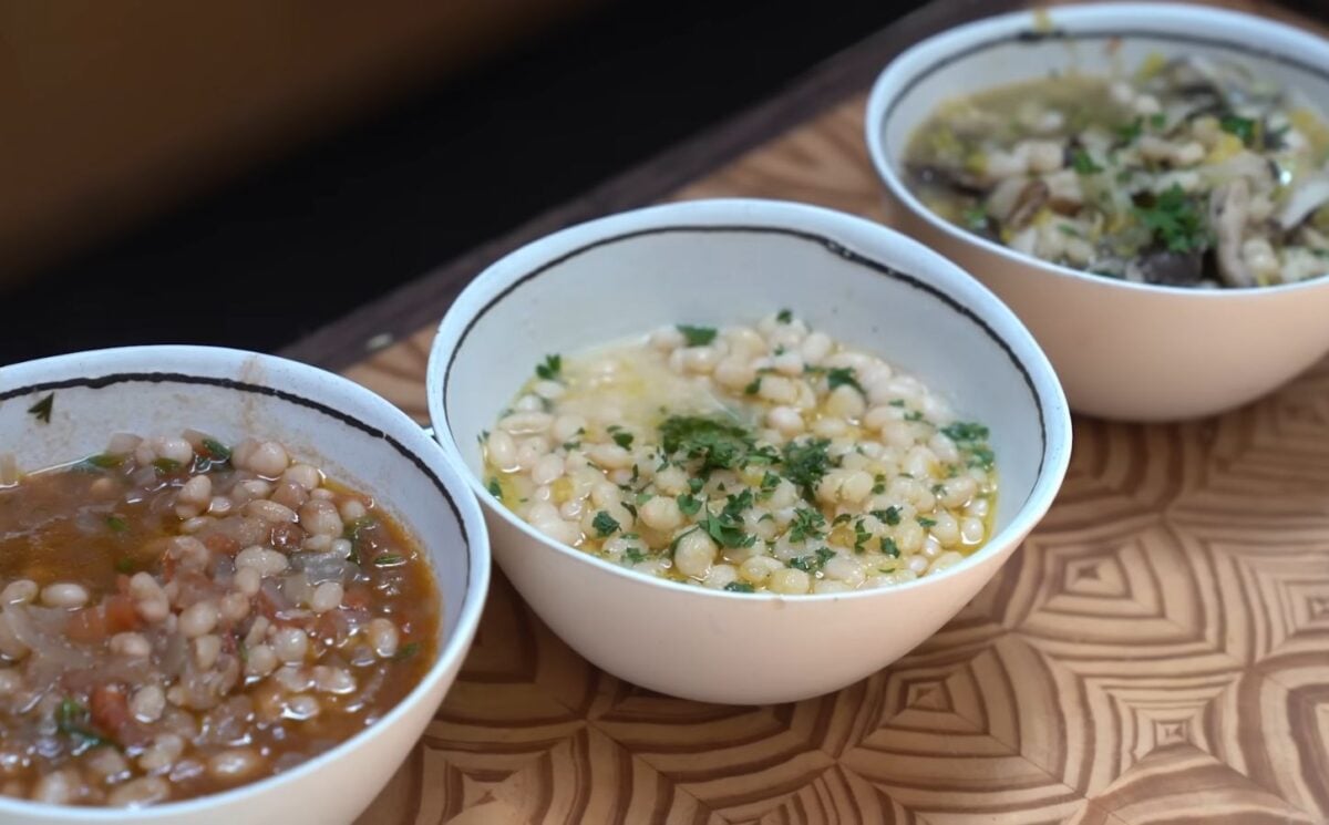 With these tomato and herb, lemon and miso, and leek and mushroom beans, viewed here in white and blue bowls on a wooden table, Miyoko Schinner is making beans sexy again