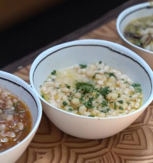 With these tomato and herb, lemon and miso, and leek and mushroom beans, viewed here in white and blue bowls on a wooden table, Miyoko Schinner is making beans sexy again
