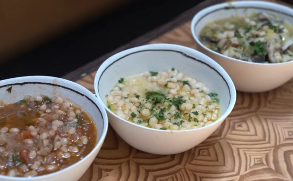 With these tomato and herb, lemon and miso, and leek and mushroom beans, viewed here in white and blue bowls on a wooden table, Miyoko Schinner is making beans sexy again