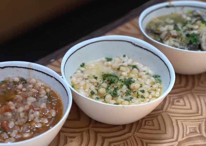With these tomato and herb, lemon and miso, and leek and mushroom beans, viewed here in white and blue bowls on a wooden table, Miyoko Schinner is making beans sexy again