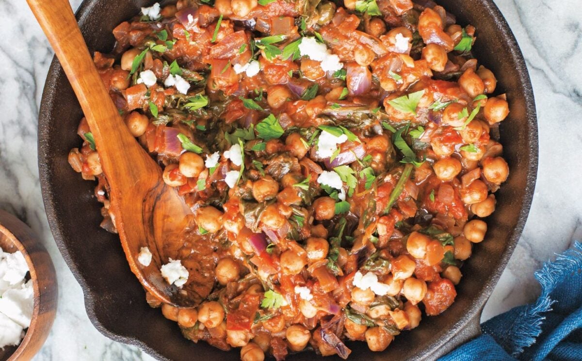 a bowl of Mediterranean chickpea spinach stew with onion, garlic, and balsamic