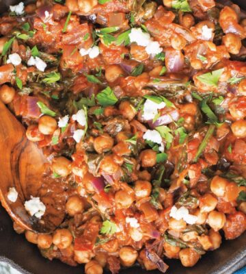 a bowl of Mediterranean chickpea spinach stew with onion, garlic, and balsamic