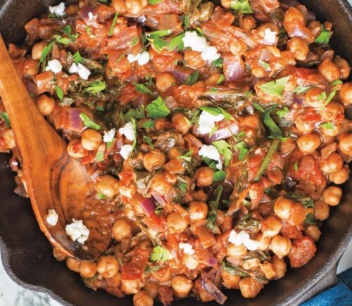 a bowl of Mediterranean chickpea spinach stew with onion, garlic, and balsamic