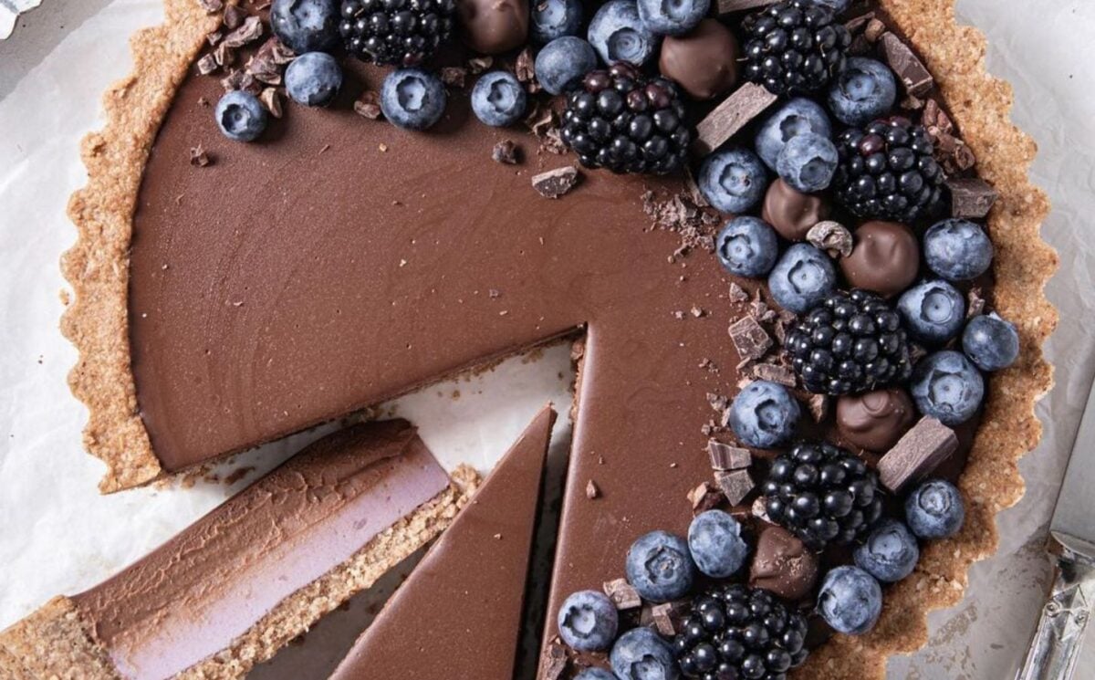blackberry custard tart with chocolate ganache, an oat crust, and two layers of filling