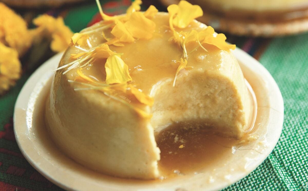 a picture of a vegan coconut flan made with tofu, coconut milk and cream, agar powder, sugar, vanilla, and topped with a syrup and edible flowers for innovative ways to use tofu