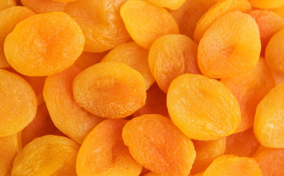 A close-up shot of bright orange dried apricots