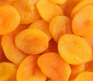 A close-up shot of bright orange dried apricots