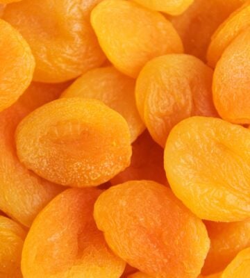 A close-up shot of bright orange dried apricots
