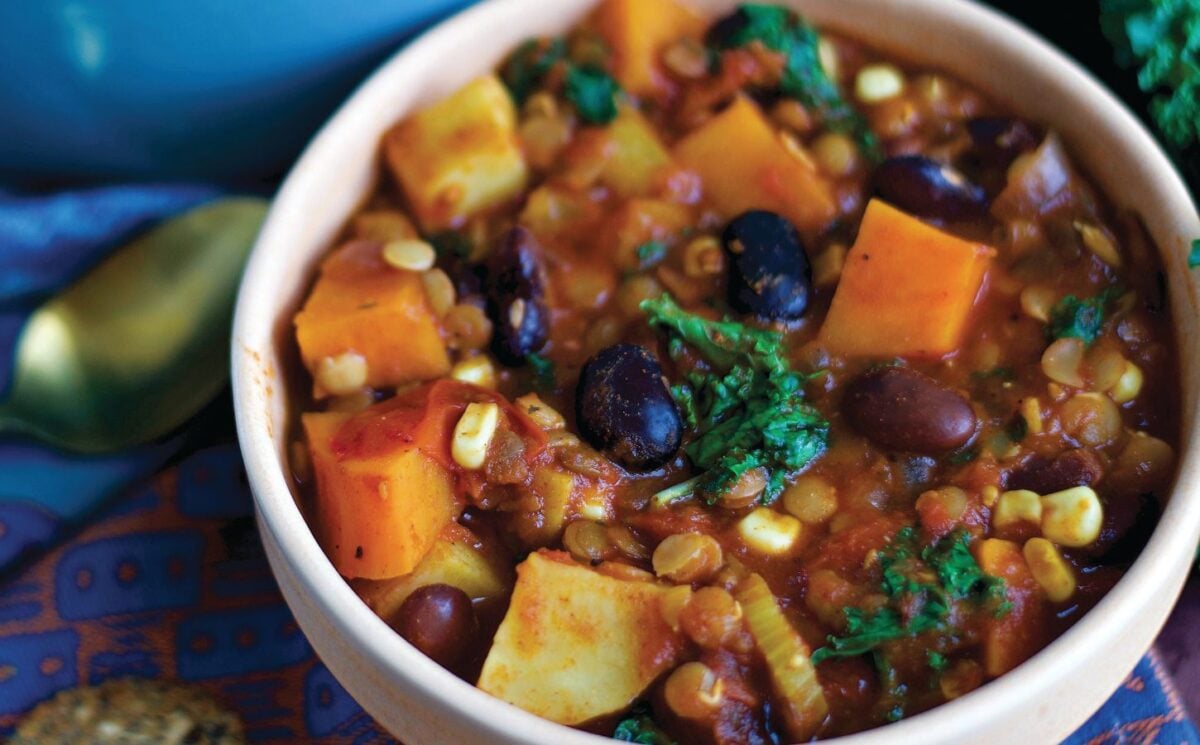 a bowl of sweet potato and kale chili with avocado in a list of recipes of healthy benefits of kidney beans