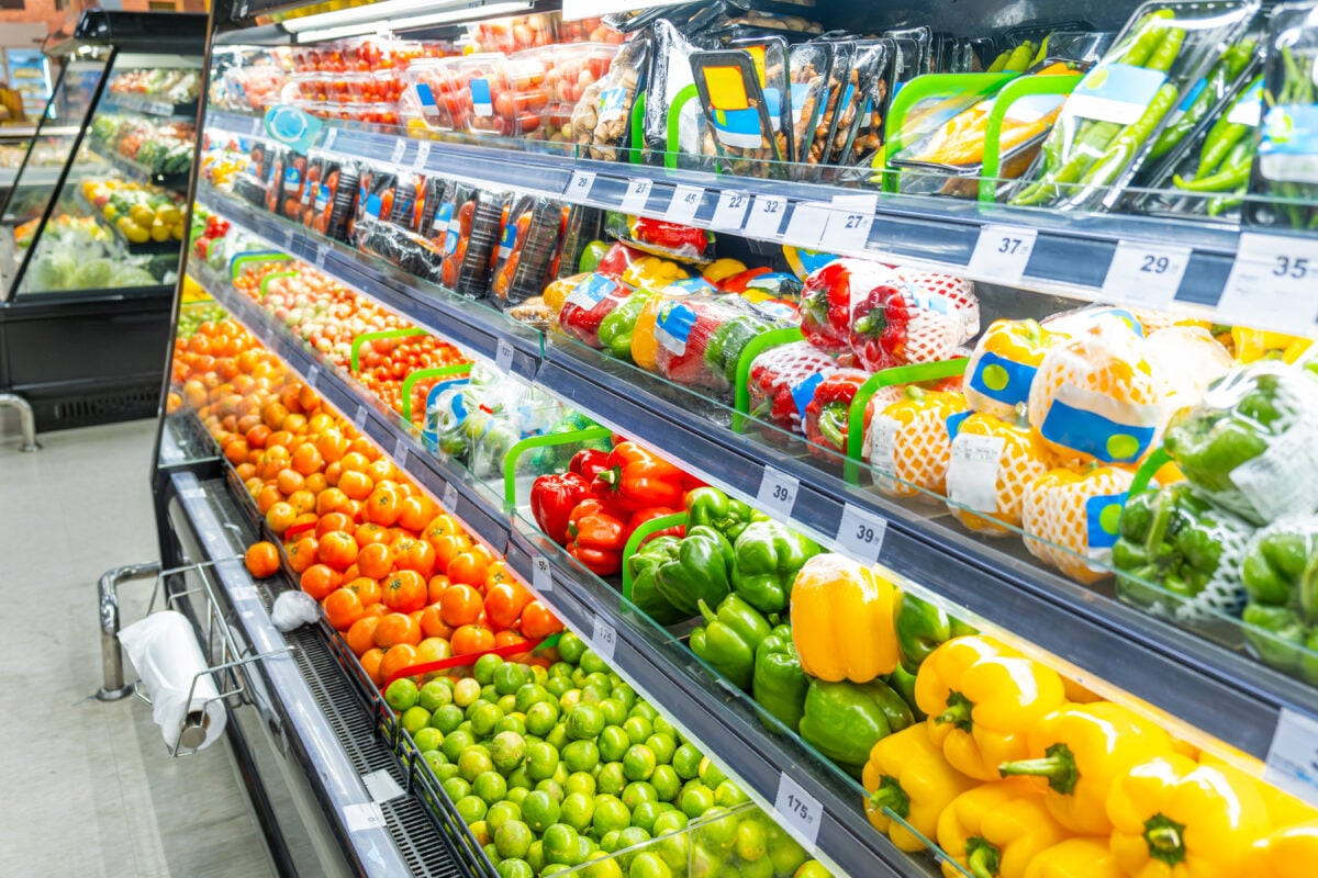 Photo shows a selection of refrigerated vegetagles in the aisle of a supermarket