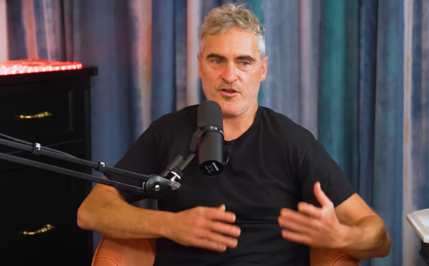 Photo show's Joaquin Phoenix speaking to Theo Von on his This Past Weekend podcast