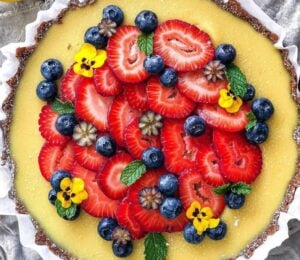 gluten-free and vegan lemon tart with fresh strawberries on top for vegan sweet tart ideas