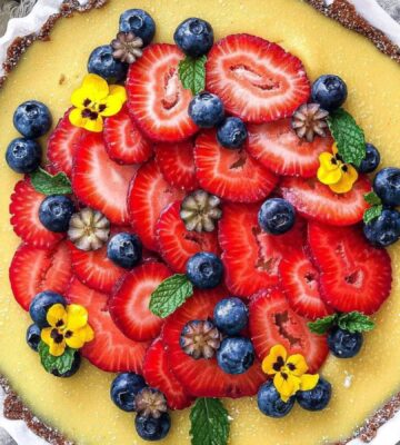 gluten-free and vegan lemon tart with fresh strawberries on top for vegan sweet tart ideas