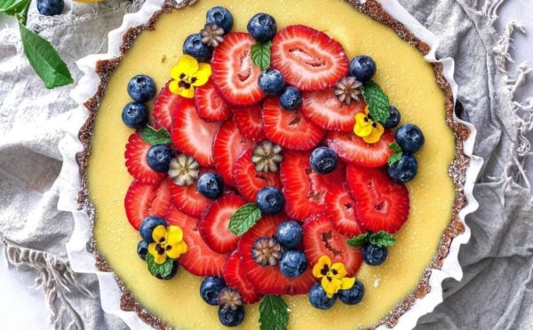gluten-free and vegan lemon tart with fresh strawberries on top for vegan sweet tart ideas