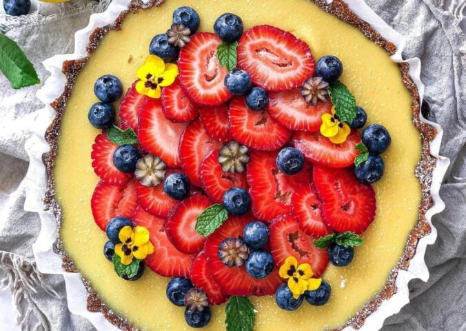 gluten-free and vegan lemon tart with fresh strawberries on top for vegan sweet tart ideas