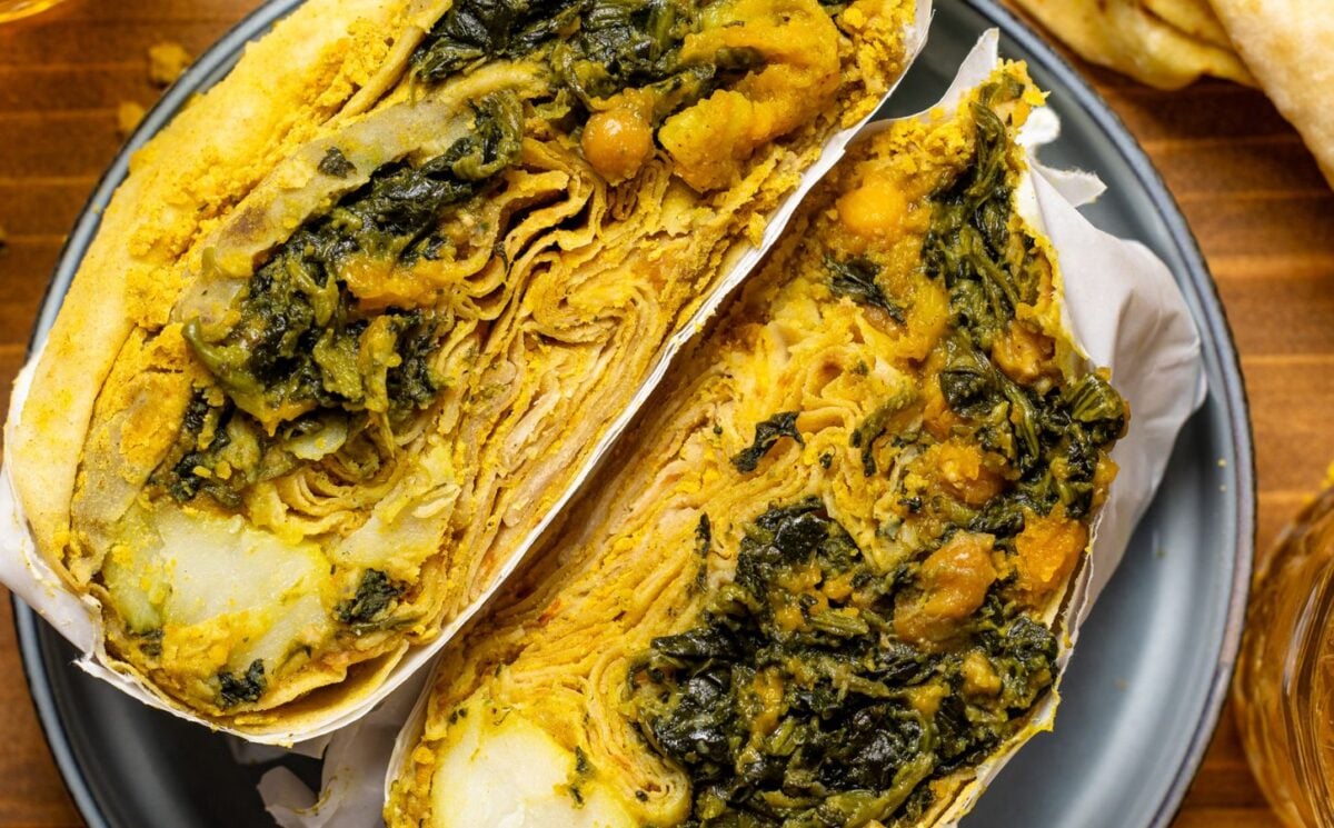 a loaded dhal puri roti with chana, aloo, and spinach for high-protein vegan comfort food recipes