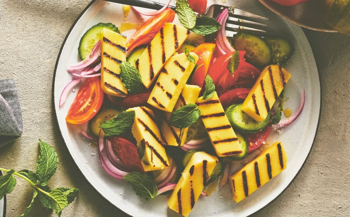 golden grilled malloumi, a vegan take on halloumi on a plate with salad