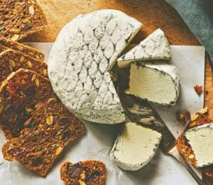 A wheel of snow white rind vegan cheese like brie or camembert