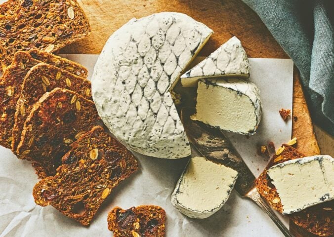 A wheel of snow white rind vegan cheese like brie or camembert