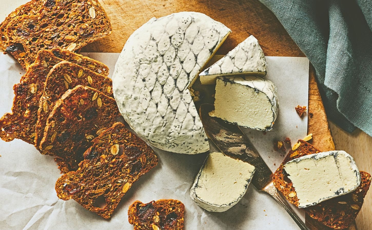 A wheel of snow white rind vegan cheese like brie or camembert