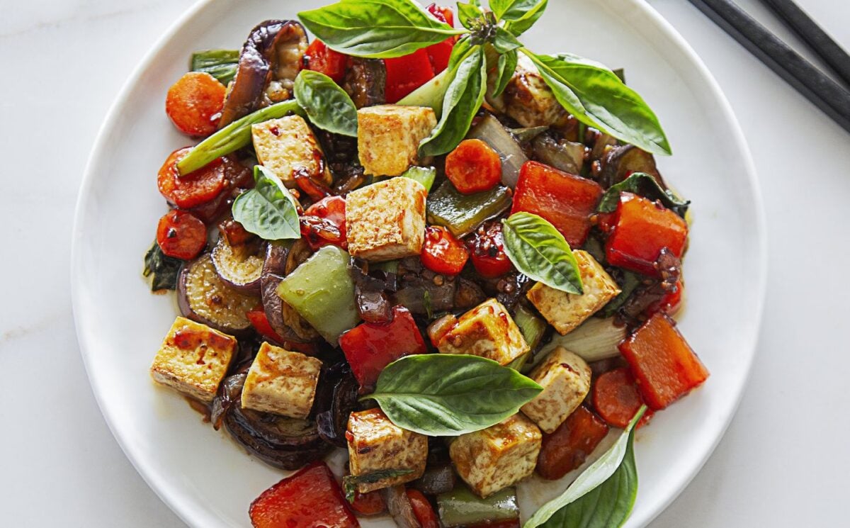 vegan spicy eggplant with tofu, chinese aubergine, peppers, and Thai basil