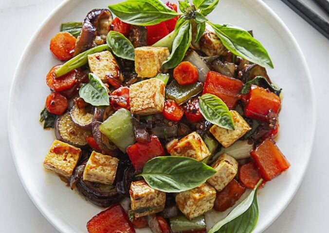 vegan spicy eggplant with tofu, chinese aubergine, peppers, and Thai basil