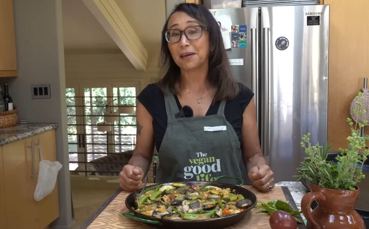 Miyoko Schinner stands in her kitchen over a pan of vegan paella that she just prepared