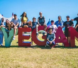 Vegan Camp Out attendees at the festival posting against some large letters reading "Vegan"