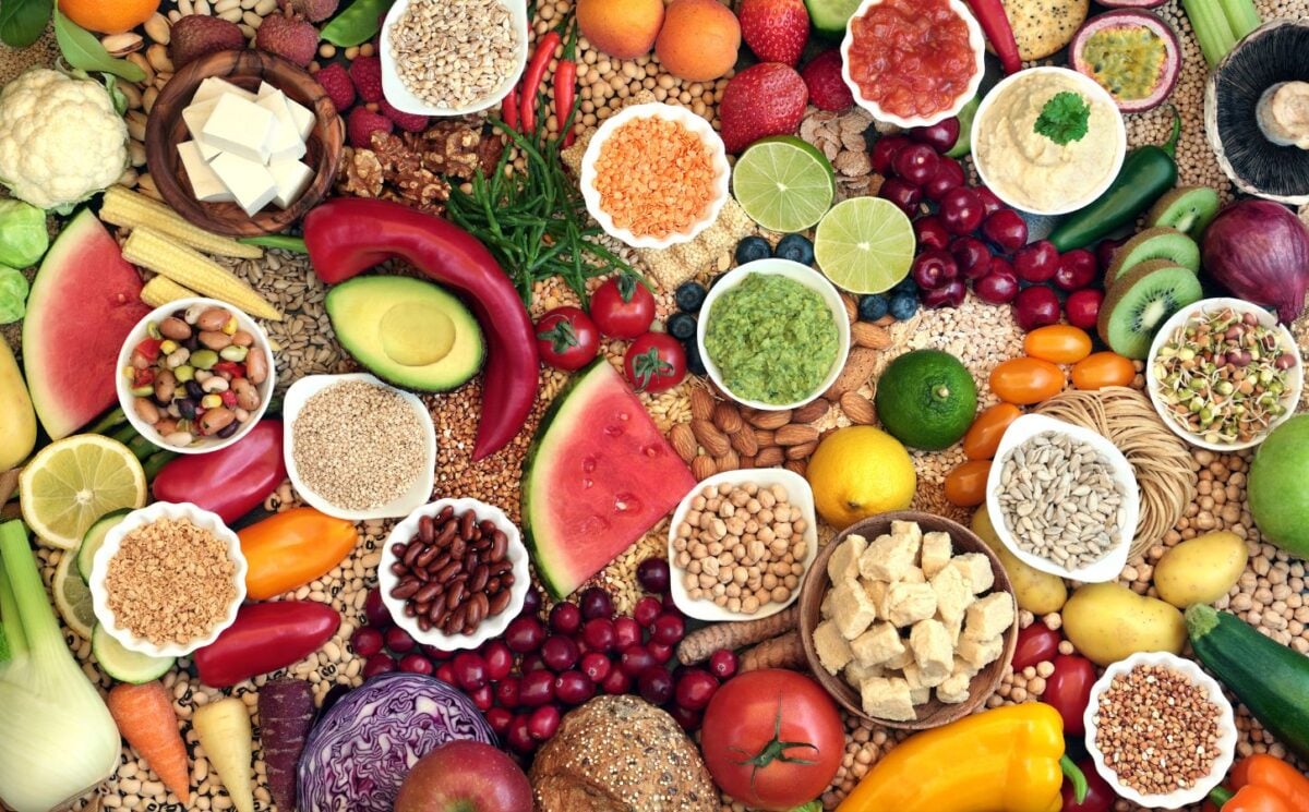 A selection of fruits and vegetables making up a whole foods, plant-based diet, which can reduce cancer risk