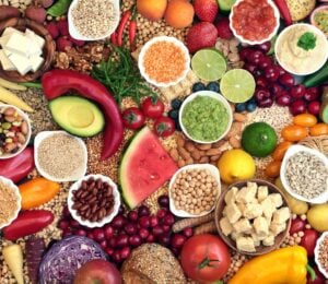 A selection of fruits and vegetables making up a whole foods, plant-based diet, which can reduce cancer risk