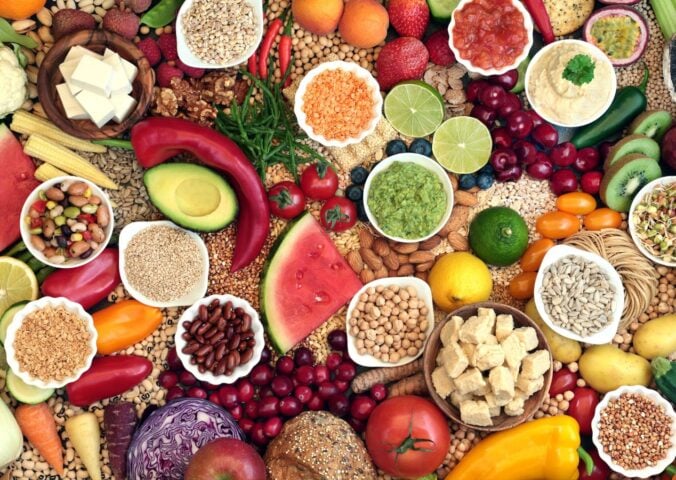 A selection of fruits and vegetables making up a whole foods, plant-based diet, which can reduce cancer risk