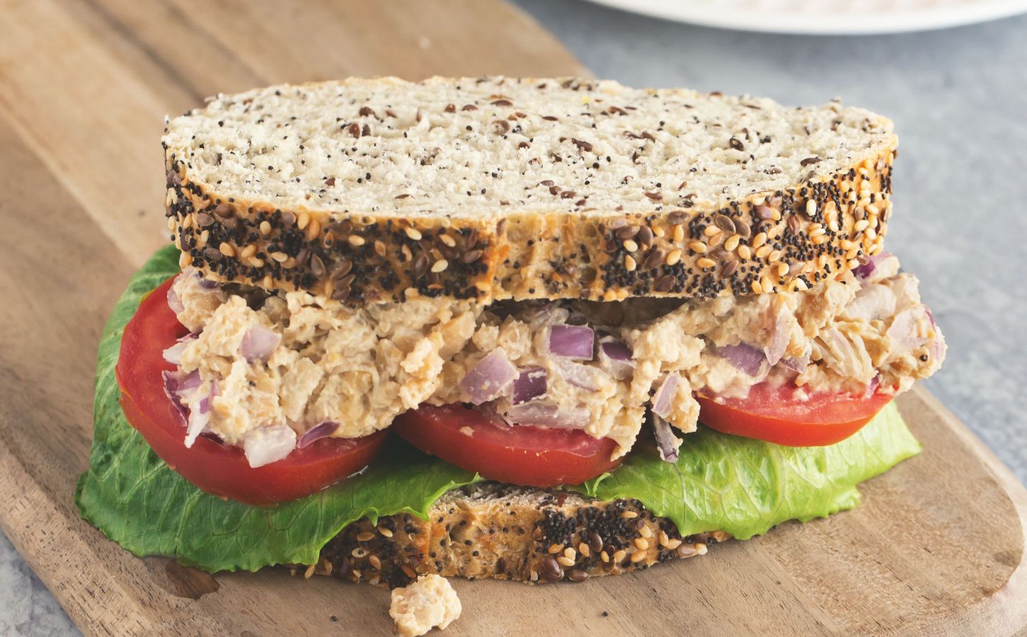 Caesar smashed chickpea sandwiches with tomato and lettuce for vegan lunchbox ideas kids will love