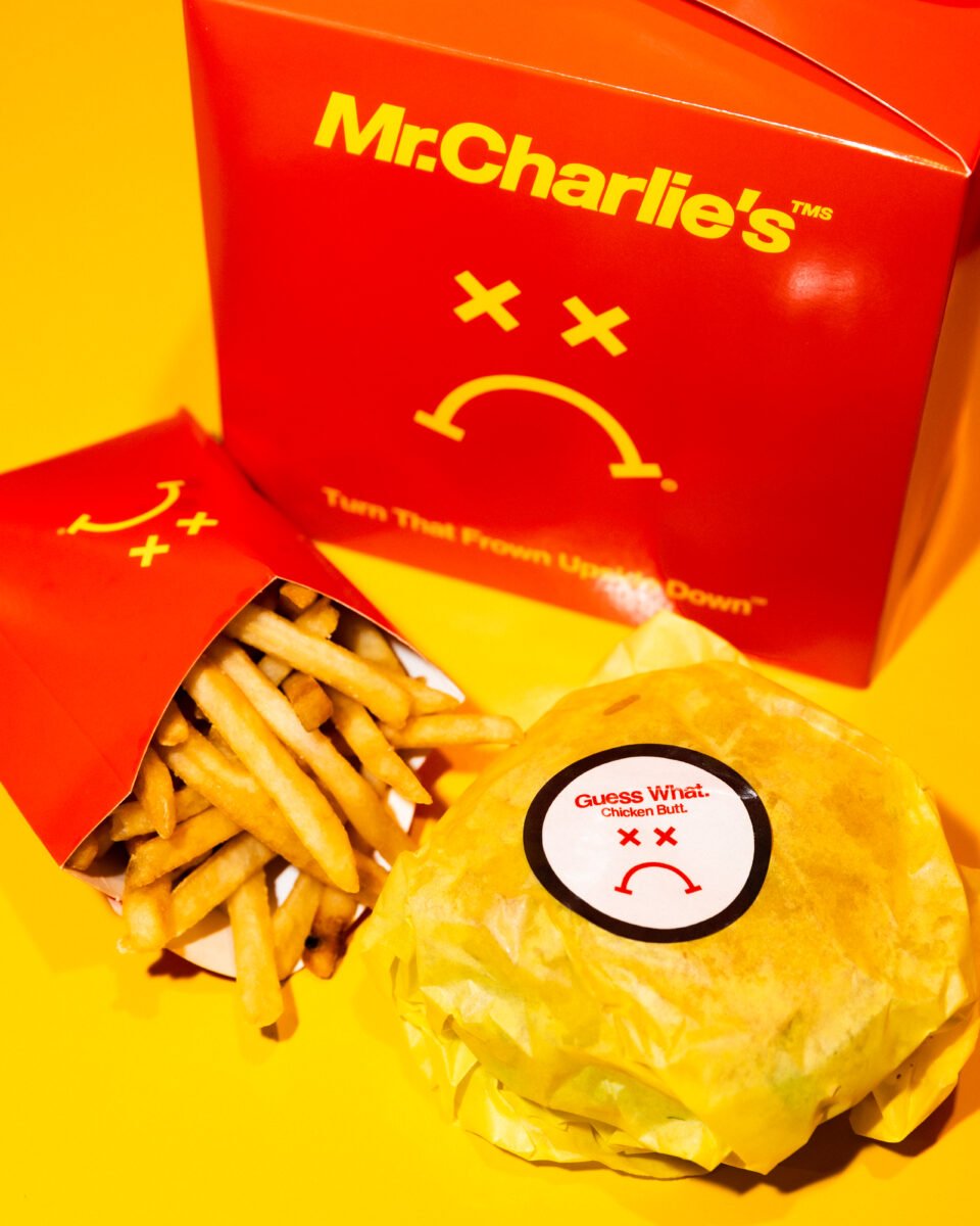 Photo shows a Mr Charlie's vegan "Frowny Meal," fries, and a plant-based chicken burger