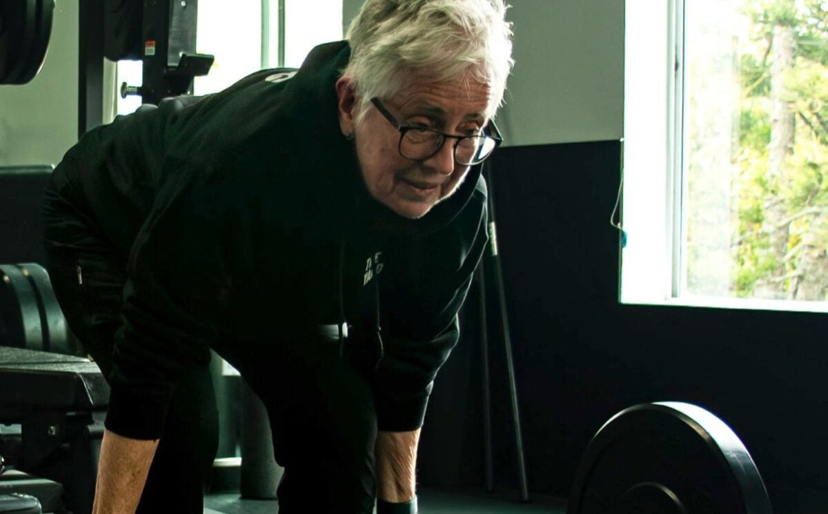 Photo shows Sister Pat Farrell, a vegan nun and 72 year old powerlifter, deadlifting a barbell