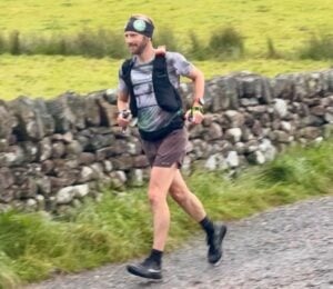 Photo shows vegan runner Damian Hall competing in the Lakeland 100 earlier this year