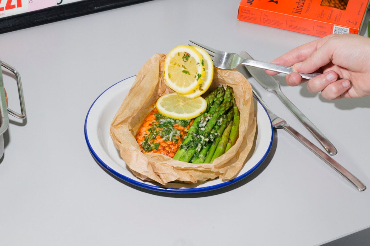 Photo shows a baked portion of the new Juicy Marbles & Friends plant-based salmon fillet, alongside lemon and greens