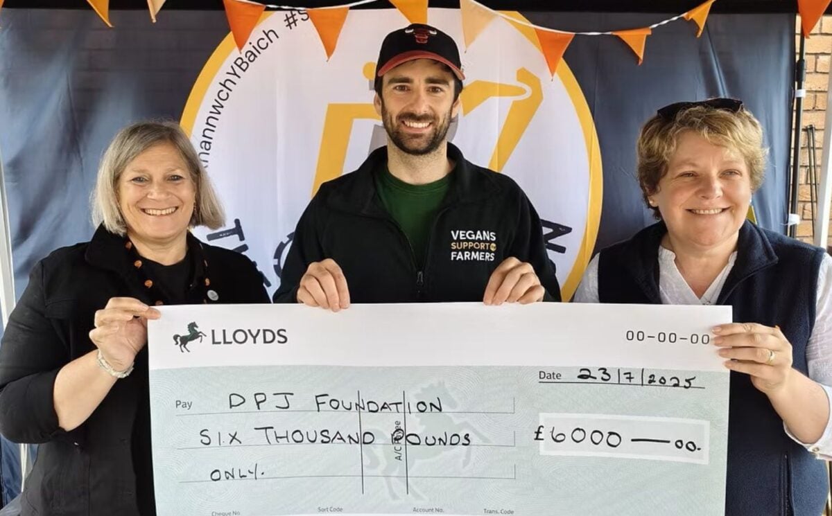 Photo shows people from Vegans Support the Farmers and the DPJ Foundation holding a cheque for the final amount at the Royal Welsh Show