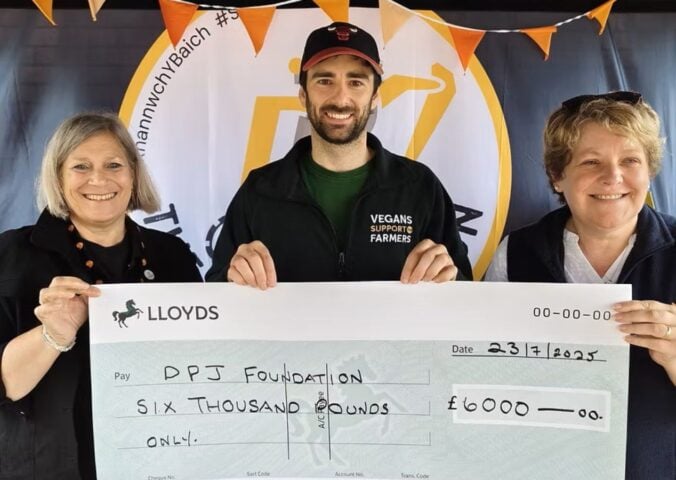 Photo shows people from Vegans Support the Farmers and the DPJ Foundation holding a cheque for the final amount at the Royal Welsh Show